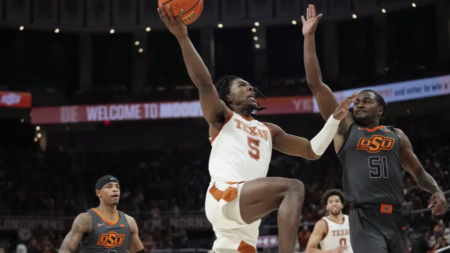 Texas guard Marcus Carr (5) drives to the basket against Oklahoma State guard John-Michael Wright (51) during the second half of an NCAA college basketball game in Austin, Texas, Tuesday, Jan. 24, 2023. (AP Photo/Eric Gay)