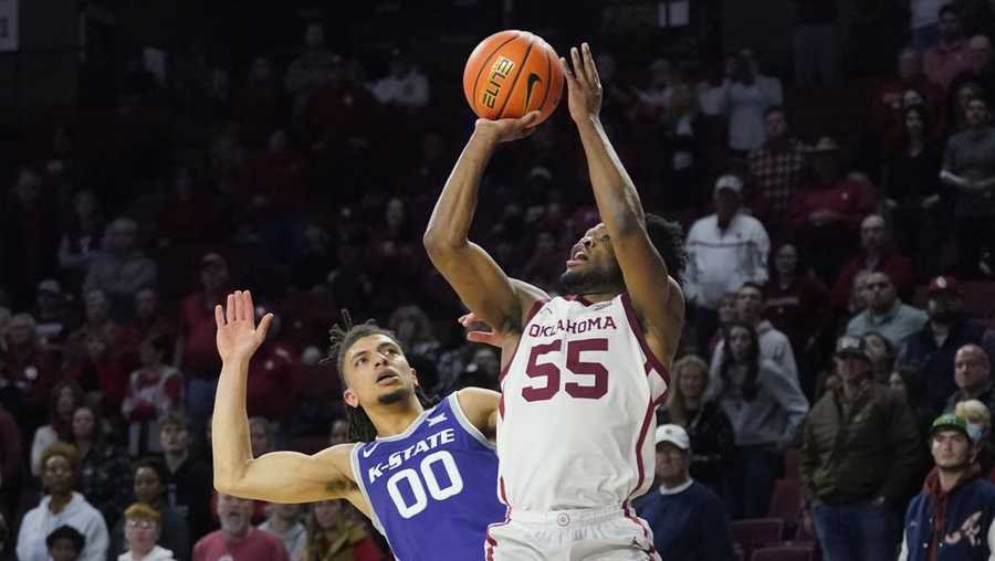 Oklahoma guard Elijah Harkless (55) shoots in front of Kansas State guard Mike McGuirl (00) in the second half of an NCAA college basketball game Saturday, Jan. 1, 2022, in Norman, Okla. (AP Photo/Sue Ogrocki)