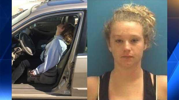 In this Saturday, Oct. 22, 2016 photo provided by the Town of Hope Police Department, Erika Hurt sits with her baby in the back seat of the car in Hope, Ind. Police said she appeared unresponsive from an overdose and had a syringe in her hand. 