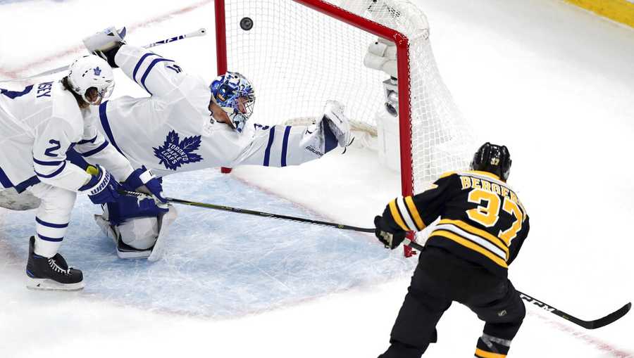 Boston Bruins center Patrice Bergeron (37) beats Toronto Maple Leafs goaltender Frederik Andersen for a goal during the first period of an Game 1 of an NHL hockey first-round playoff series Thursday, April 11, 2019, in Boston. At left is Maple Leafs defenseman Ron Hainsey. (AP Photo/Charles Krupa)