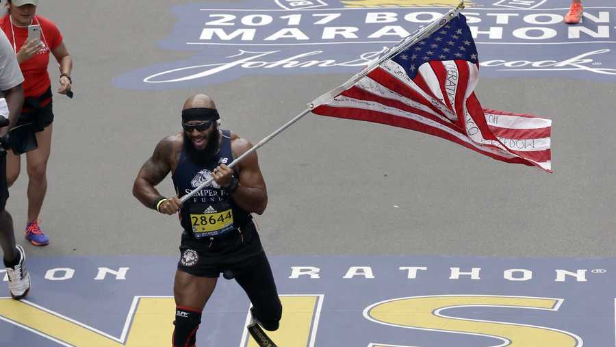 Wounded Marine runs Boston Marathon carrying US flag, inspires others