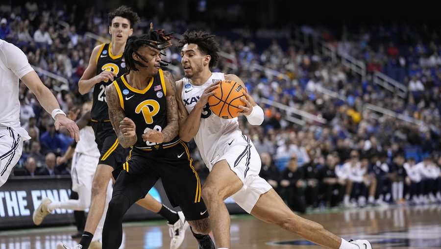 Xavier guard Colby Jones (3) drives against Pittsburgh guard Nike Sibande (22)during the first half of a second-round college basketball game in the NCAA Tournament on Sunday, March 19, 2023, in Greensboro, N.C. (AP Photo/John Bazemore)