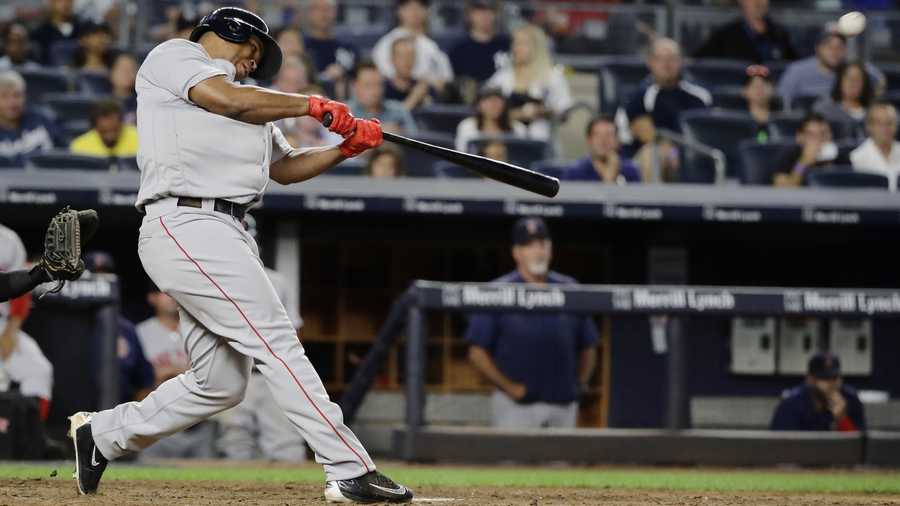 Boston Red Sox's Rafael Devers hits a home run during the ninth inning of the team's baseball game against the New York Yankees on Sunday, Aug. 13, 2017, in New York.