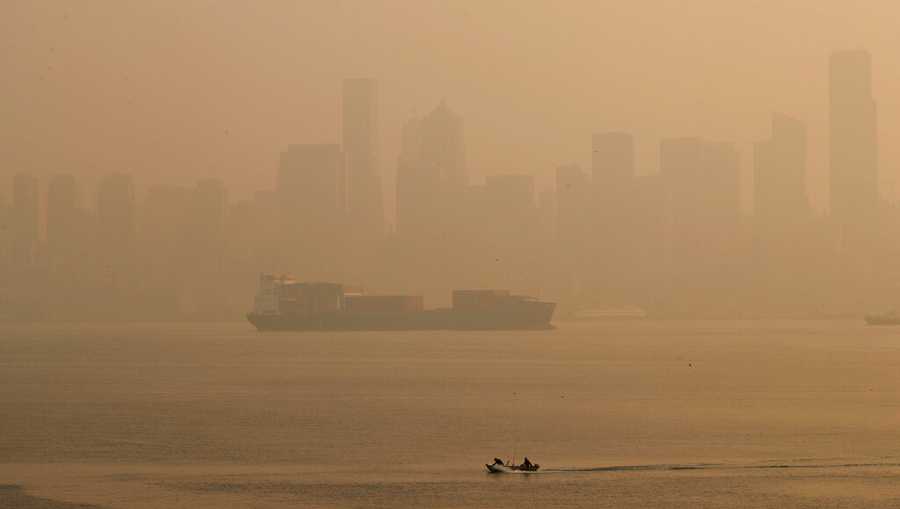 Boaters pass by the Seattle skyline during hazy air conditions Friday morning, Sept. 11, 2020. Smoke pollution from wildfires raging in California and across the Pacific Northwest worsened in San Francisco, Seattle and Portland, Oregon, on Friday, giving those cities and others in the the region some of the world’s worst air quality. (Erika Schultz/The Seattle Times via AP)