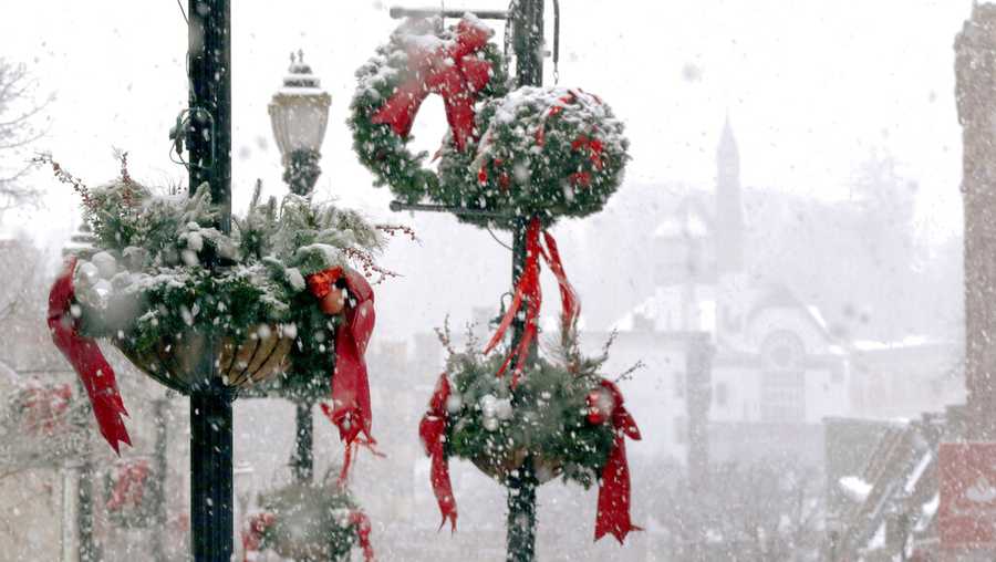 Snow clings to holiday decorations, Saturday, Dec. 5, 2020, in downtown Marlborough, Mass. The northeastern United States is seeing the first big snowstorm of the season.(AP Photo/Bill Sikes)