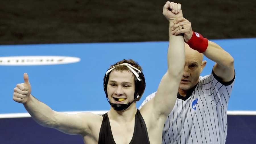 In this March 23, 2019, file photo, Iowa's Spencer Lee, left, celebrates his win over Virginia's Jack Mueller (not shown) in their 125-pound match in the finals of the NCAA wrestling championships in Pittsburgh.