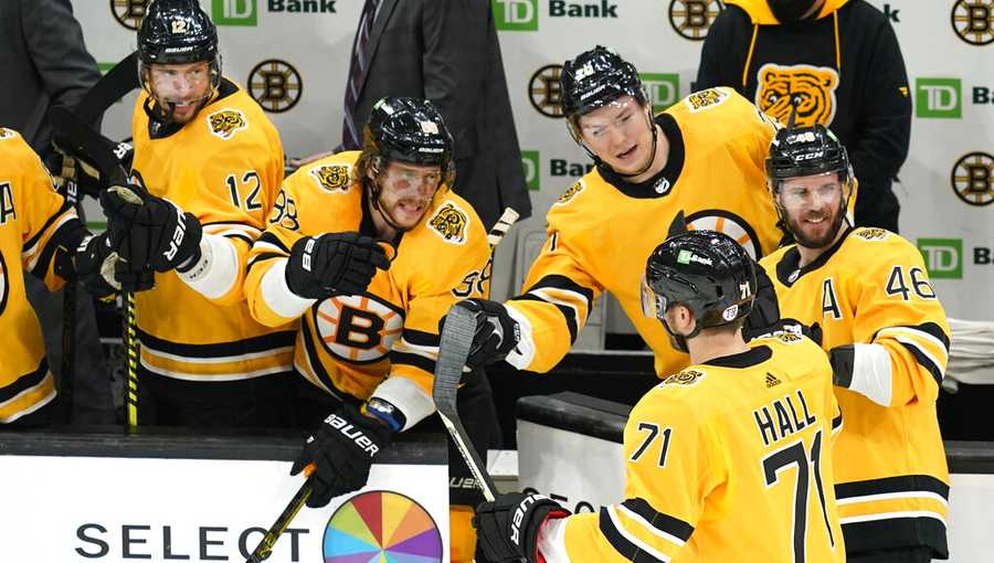 Boston Bruins left wing Taylor Hall (71) celebrates his goal with teammates on the bench in the third period of an NHL hockey game against the New York Islanders, Thursday, April 15, 2021, in Boston. (AP Photo/Elise Amendola)