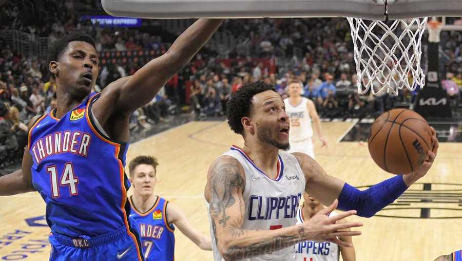 Los Angeles Clippers guard Amir Coffey, right, shoots as Oklahoma City Thunder forward Jaylen Hoard defends during the second half of an NBA basketball game Sunday, April 10, 2022, in Los Angeles. (AP Photo/Mark J. Terrill)