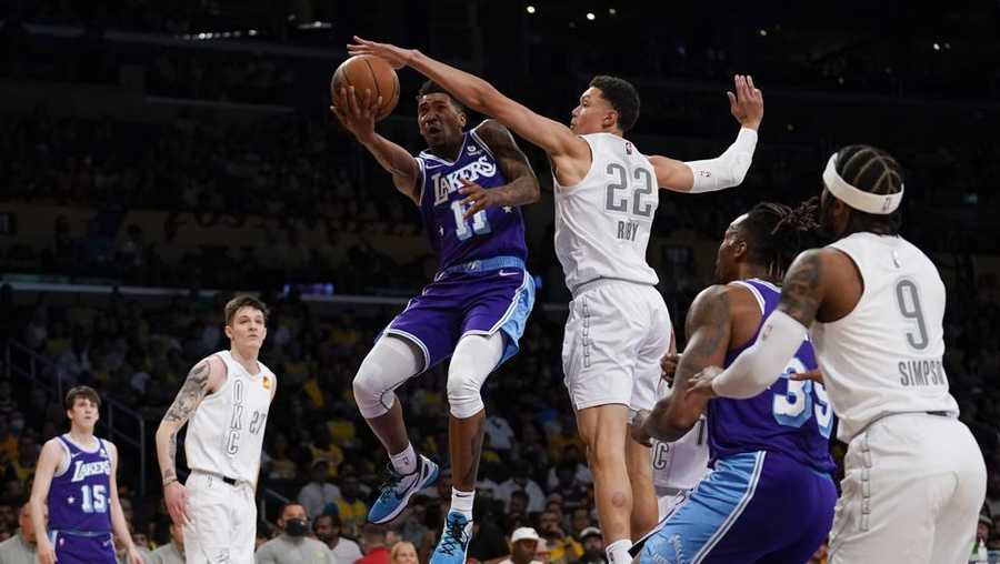 Los Angeles Lakers guard Malik Monk (11) shoots against Oklahoma City Thunder forward Isaiah Roby (22) during the first half of an NBA basketball game in Los Angeles, Friday, April 8, 2022. (AP Photo/Ashley Landis)