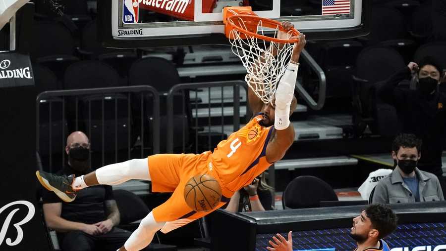 Phoenix Suns guard Jevon Carter (4) dunks over Oklahoma City Thunder guard Ty Jerome during the first half of an NBA basketball game Friday, April 2, 2021, in Phoenix. (AP Photo/Rick Scuteri)