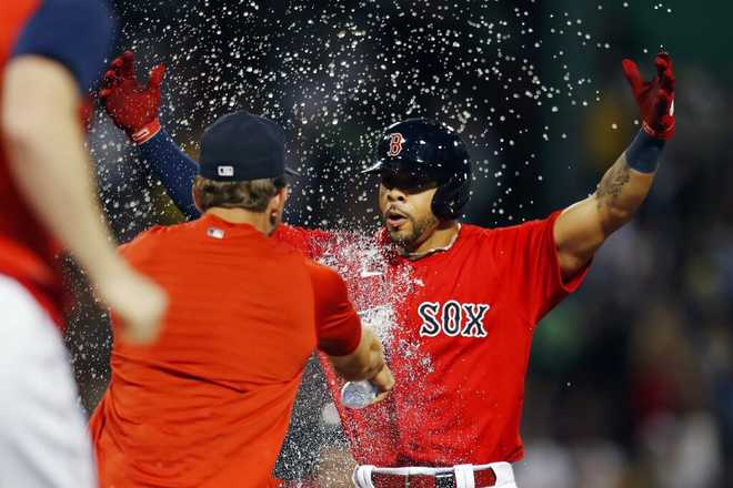 Boston   Red   Sox'  s   Tommy   Pham, & # x20;  right,    celebrates & # x20;  after & # x20;  hit & # x20;  a   Exit & # x20;  RBI-single & #x20;  during & # x20;  the & #x20;  10th    inning & # x20;  of & #x20;  a   baseball   game   against & # x20;  the & #x20;  New & #x20;  York   Yankees, & # x20;  Friday, & # x20;  August   12, & # x20;  2022, & # x20;  in & # x20;  Boston.