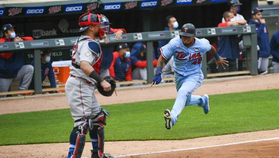 Max Kepler slides into home plate for the first run of the game during the  third inning.