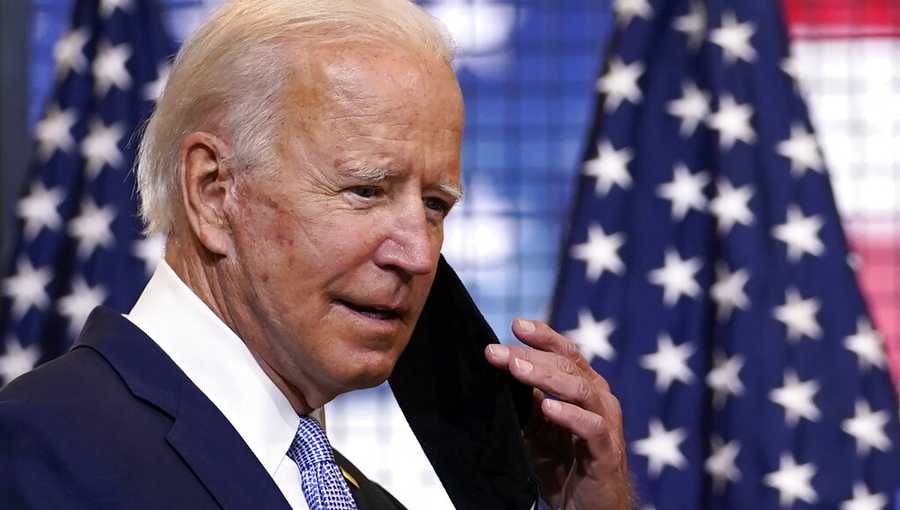 Democratic presidential candidate former Vice President Joe Biden removes his face mask as he arrives to speak at a campaign event at Mill 19 in Pittsburgh, Pa., Monday, Aug. 31, 2020. (AP Photo/Carolyn Kaster)