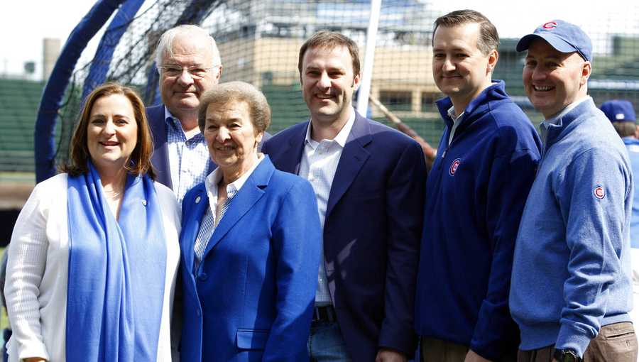 FILE - In this April 12, 2010 file photo, Chicago Cubs owner Tom Ricketts, second from right, and family members pose on the field before the Chicago Cubs baseball home opener against the Milwaukee Brewers in Chicago. From left are Cubs board member Laura Rickets, Joe Ricketts, Marlene Ricketts, board member Todd Ricketts, board Chairman Tom Ricketts and board member Pete Rickets. Most of the Ricketts family who own the Chicago Cubs who are playing in the World Series are Republicans who are supporting Republican Donald Trump. Daughter Laura Ricketts, meanwhile, is a top Democratic donor who held a high-dollar fundraiser for Hillary Clinton this summer and was a super delegate for her to the Democratic National Convention. (AP Photo/Nam Y. Huh, File)