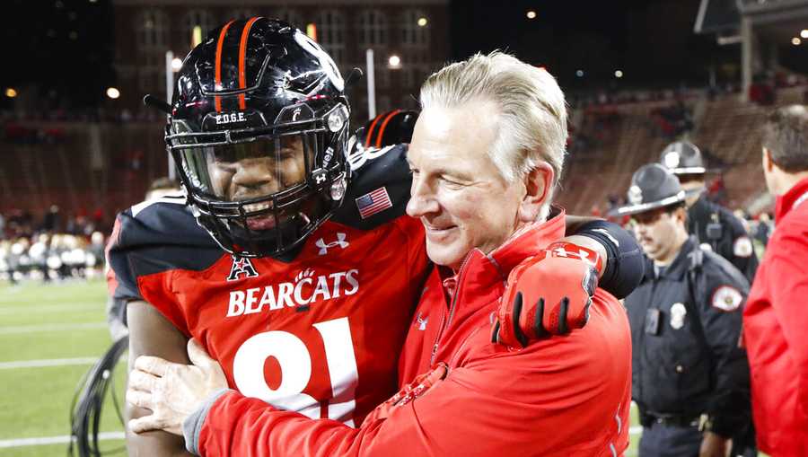 Cincinnati head coach Tommy Tuberville, right, celebrates with tight end DJ Dowdy (81) after an NCAA college football game against East Carolina, Saturday, Oct. 22, 2016, in Cincinnati. Cincinnati won 31-19. (AP Photo/John Minchillo)