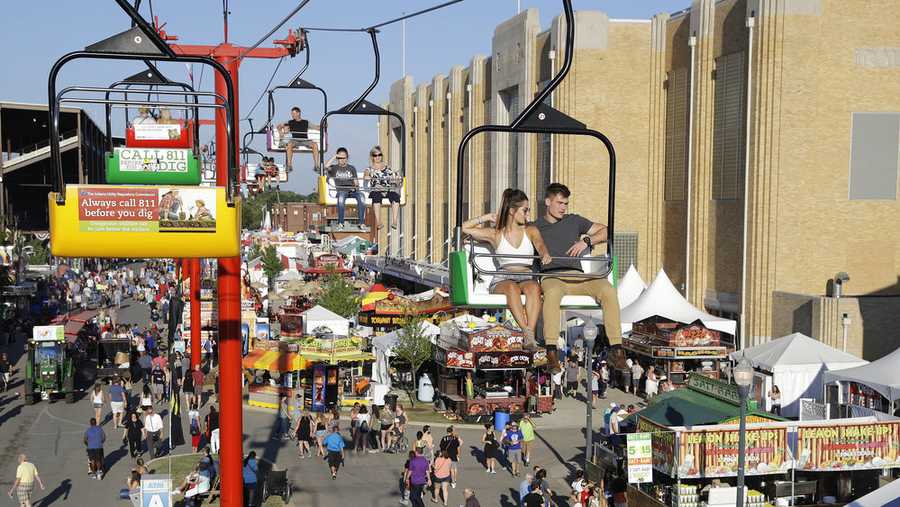 Visitors take a ride over food booths during the Indiana State Fair Wednesday, Aug. 9, 2017, in Indianapolis. The fair runs through Sunday, Aug. 20. (AP Photo/Darron Cummings)
