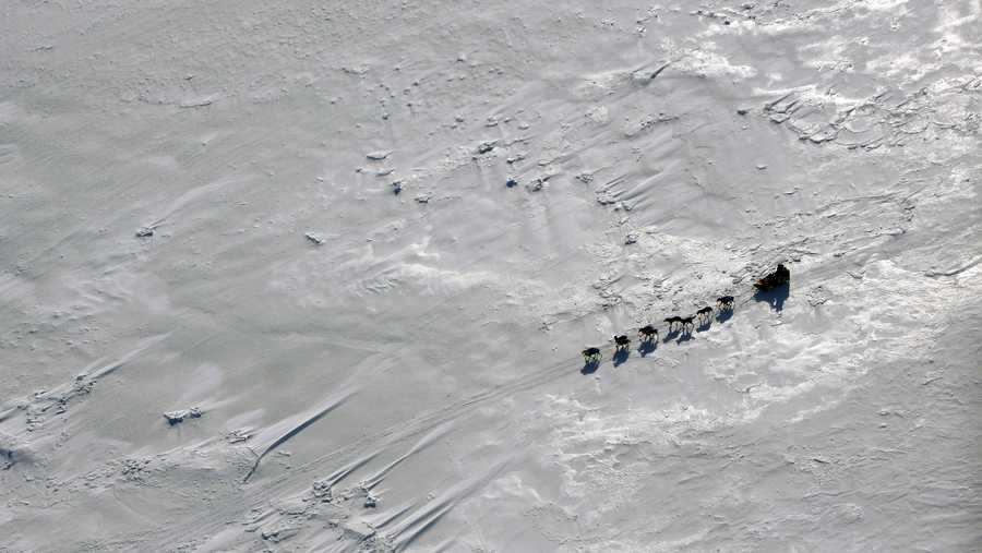FILE - This March 16, 2009 file photo shows a team driving across Norton Bay just past the Shaktoolik, Alaska checkpoint on the Iditarod Trail Sled Dog Race trail. (AP Photo/Al Grillo, File)