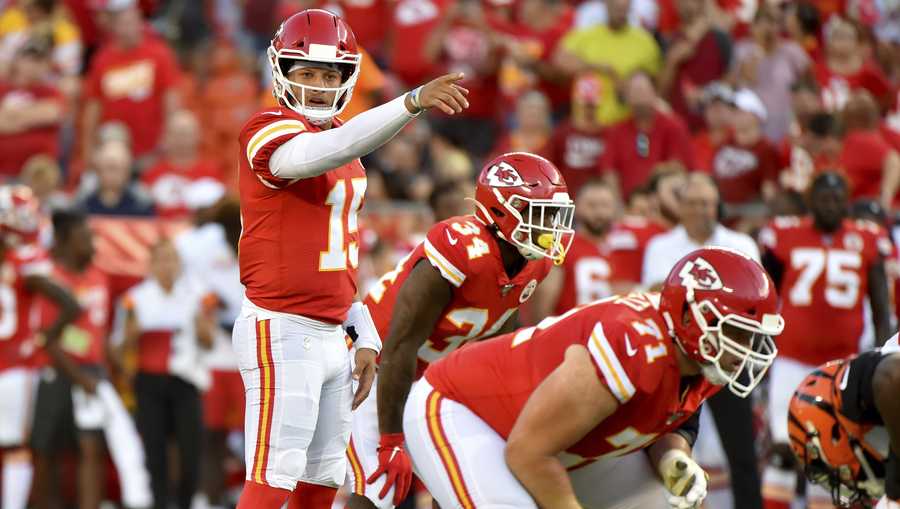 Kansas City Chiefs quarterback Patrick Mahomes (15) calls a play at the line of scrimmage behind offensive tackle Mitchell Schwartz (71), during the first half of an NFL preseason football game against the Cincinnati Bengals in Kansas City, Mo., Saturday, Aug. 10, 2019. (AP Photo/Ed Zurga)