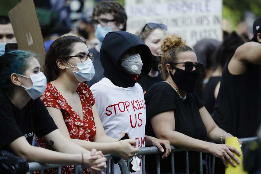 Protesters wear protective masks during a rally over the death of George Floyd, a black man who was in police custody in Minneapolis Friday, May 29, 2020, in New York.