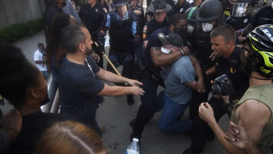 Police officers and protesters clash near CNN center on Friday in Atlanta. The protest started peacefully earlier in the day before demonstrators clashed with police.