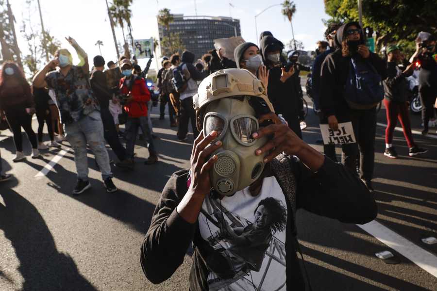 A protester puts on a gas mask in Los Angeles.