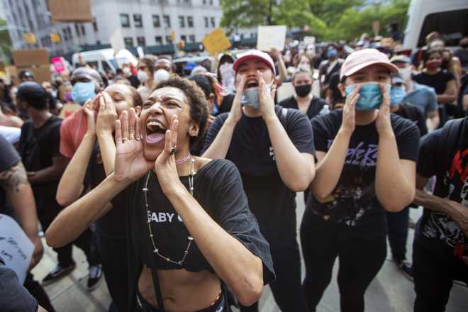 Protesters demonstrate against the the death of George Floyd, a black man who was in police custody in Minneapolis, Friday, May 29, 2020, in New York.