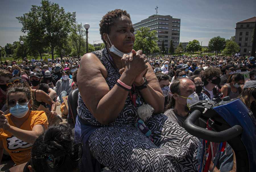 Stephanie Crosby, center, from Beaumont, Texas, sits on her motorized chair during a rally for George Floyd at the Minnesota state Capital on Sunday May 31, 2020, in St. Paul, Minn. Protests were held in U.S. cities over the death of Floyd, a black man who died after being restrained by Minneapolis police officers on May 25. (AP Photo/Bebeto Matthews)