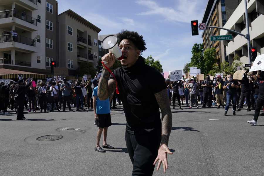 Demonstrators yell outside the Long Beach Police Department on Sunday, May 31, 2020, in Long Beach, Calif., during a protest over the death of George Floyd. Floyd died May 25 after he was pinned at the neck by a Minneapolis police officer.