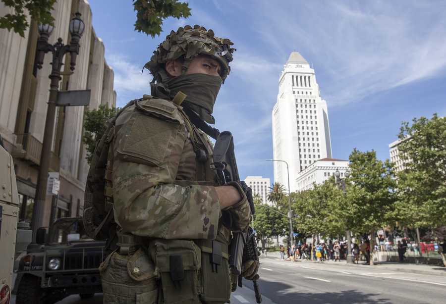 A member of the California National Guard stands watch near City Hall, Sunday, May 31, 2020, in Los Angeles.