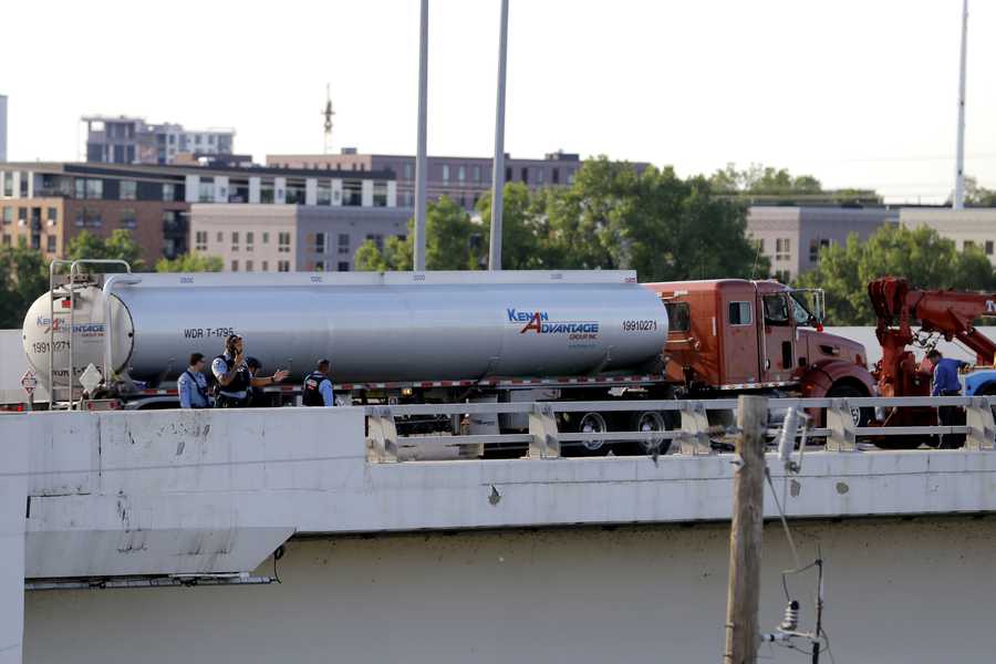 Authorities stand near a large truck on a bridge, Sunday, May 31, 2020, in Minneapolis. Protests continued following the death of George Floyd, who died after being restrained by Minneapolis police officers on May 25. (AP Photo/Julio Cortez)