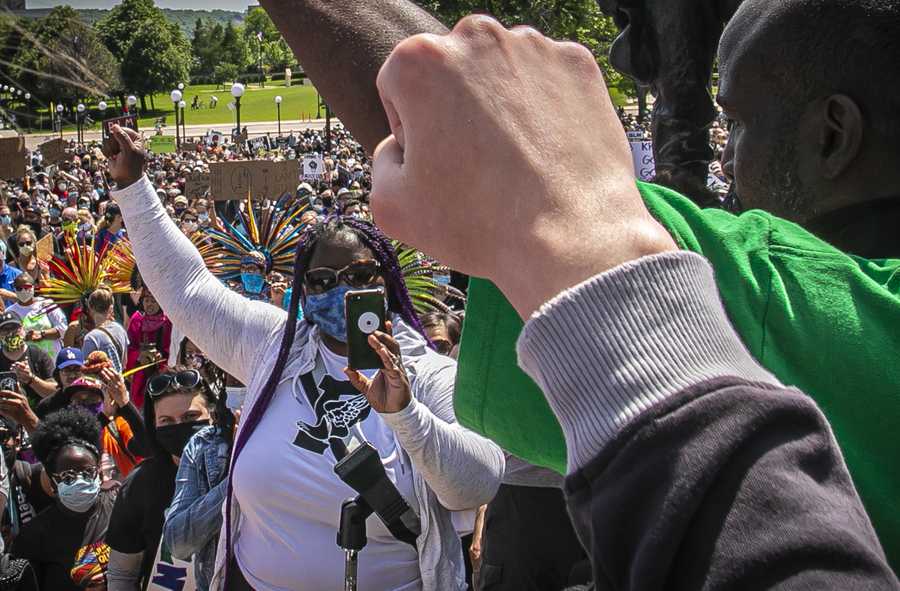Nekima Valdez Levy Armstrong, center, an activist lawyer and former president of the Minneapolis chapter of the NAACP, joins a show of fists during a rally at the State Capitol, calling for justice in the death of George Floyd while in police custody and and charges for police officers involved, Sunday, May 31, 2020, in St. Paul, Minn. (AP Photo/Bebeto Matthews)