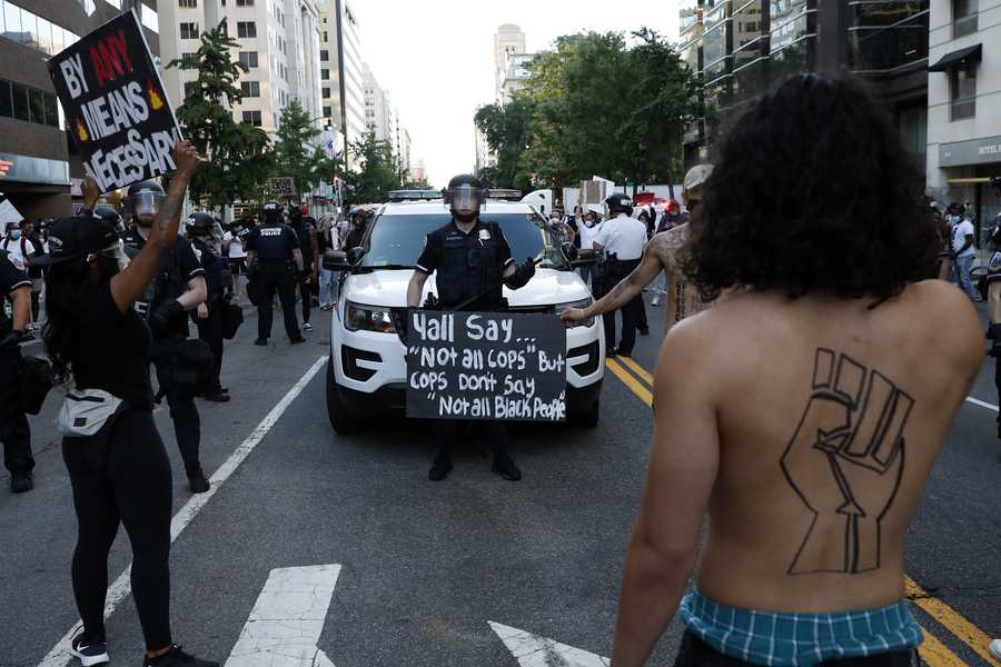 Demonstrators gather to protest the death of George Floyd, Sunday, May 31, 2020, near the White House in Washington. Demonstrators gather to protest the death of George Floyd, Sunday, May 31, 2020, near the White House in Washington.