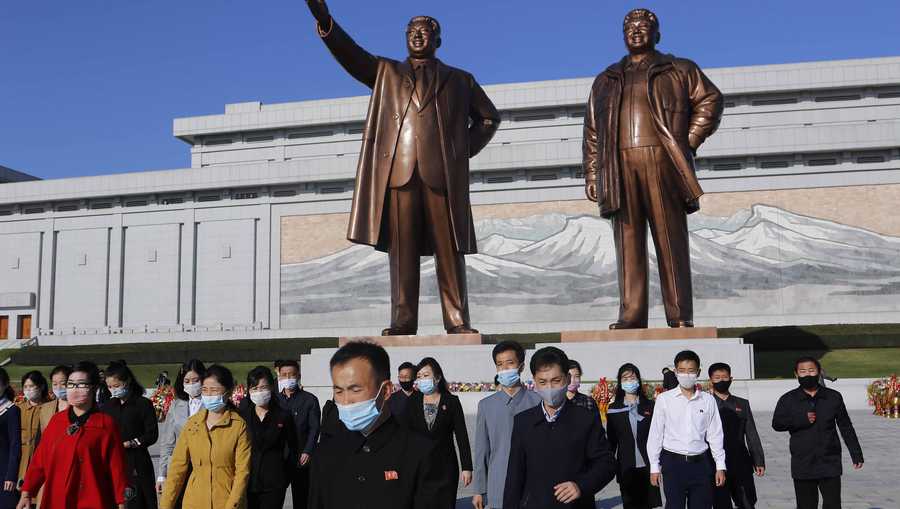 People visit the Mansu Hill to lay flowers to the bronze statues of former North Korean leaders Kim Il Sung and Kim Jong Il in Pyongyang, North Korea, Saturday, Oct. 10, 2020, on the 75th founding anniversary of the country's Workers' Party.