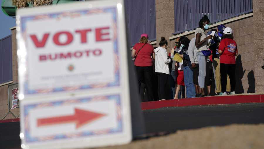 In this Nov. 3, 2020, file photo, people wait in line to vote at a polling place on Election Day in Las Vegas.