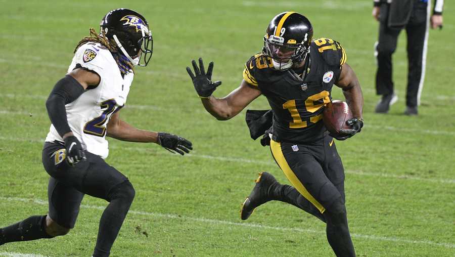 Pittsburgh Steelers wide receiver JuJu Smith-Schuster (19) runs away from Baltimore Ravens cornerback Tramon Williams after making a catch against the Baltimore Ravens during the second half of an NFL football game, Wednesday, Dec. 2, 2020, in Pittsburgh. (AP Photo/Don Wright)