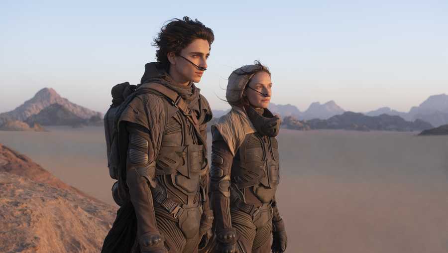 This image released by Warner Bros. Entertainment shows Timothee Chalamet, left, and Rebecca Ferguson in a scene from the upcoming 2021 film "Dune." Warner Bos. Pictures on Thursday announced that all of its 2021 film slate will stream on HBO Max at the same time they play in theaters.