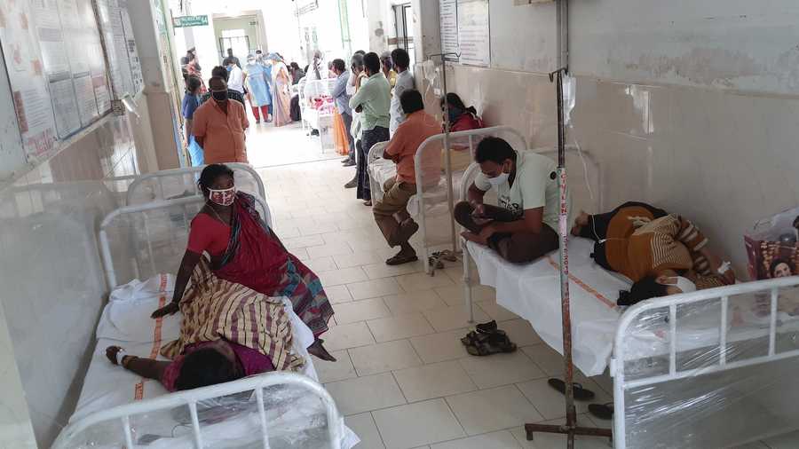 Patients and their bystanders are seen at the district government hospital in Eluru, Andhra Pradesh state, India, Sunday, Dec.6, 2020.