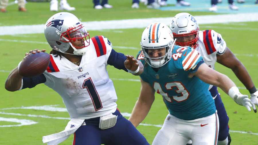New England Patriots quarterback Cam Newton (1) aims a pass as Miami Dolphins outside linebacker Andrew Van Ginkel (43) attempts to defend, during the second half of an NFL football game against the Miami Dolphins, Sunday, Dec. 20, 2020, in Miami Gardens, Fla. (AP Photo/Joel Auerbach)