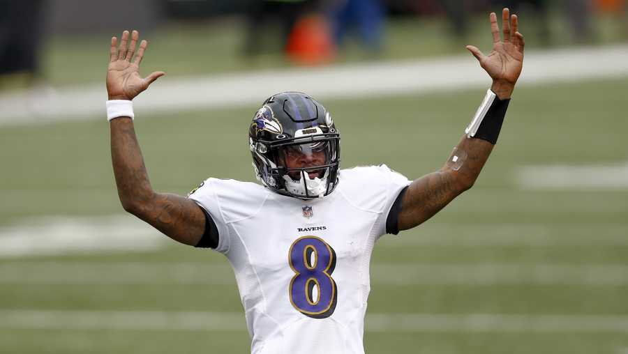 Baltimore Ravens quarterback Lamar Jackson (8) celebrates after running back J.K. Dobbins (27) ran in for a touchdown against the Cincinnati Bengals during the second half of an NFL football game, Sunday, Jan. 3, 2021, in Cincinnati. (AP Photo/Aaron Doster)