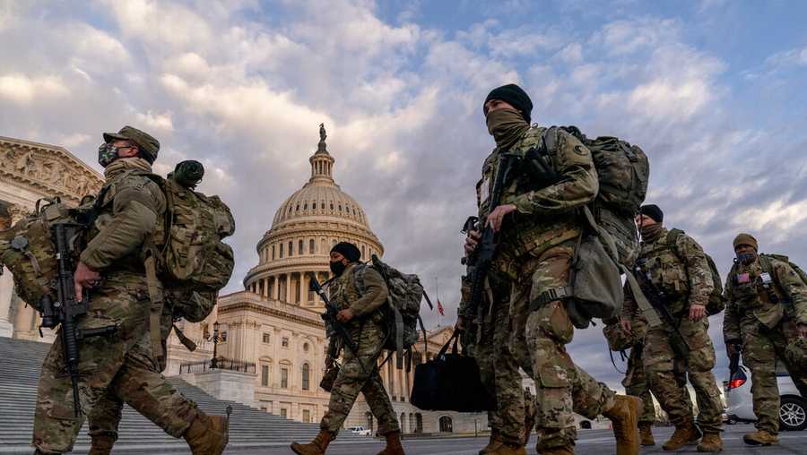 Armed National Guard troops walk past the U.S. Capitol two days before the 59th Presidential Inauguration in Washington, Monday, Jan. 18, 2021. (AP Photo/Andrew Harnik)