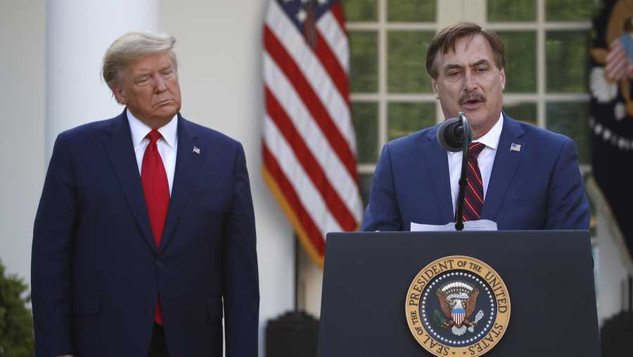 In this March 30, 2020 file photo, My Pillow CEO Mike Lindell speaks as President Donald Trump listens during a briefing about the coronavirus in the Rose Garden of the White House, in Washington.