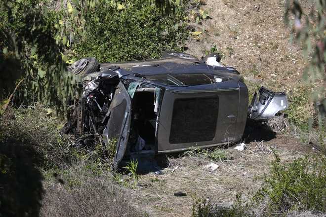A vehicle rests on its side after a rollover accident involving golfer Tiger Woods along a road in the Rancho Palos Verdes suburb of Los Angeles on Tuesday, Feb. 23, 2021.