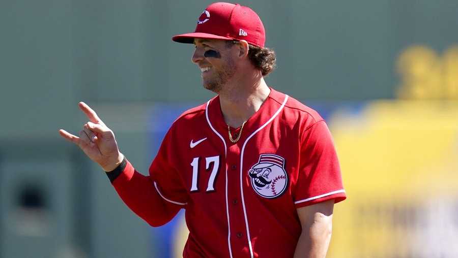 Cincinnati Reds shortstop Kyle Farmer signals to the outfield two outs against the Cleveland Indians prior to a spring training baseball game Sunday, Feb. 28, 2021, in Goodyear, Ariz. (AP Photo/Ross D. Franklin)