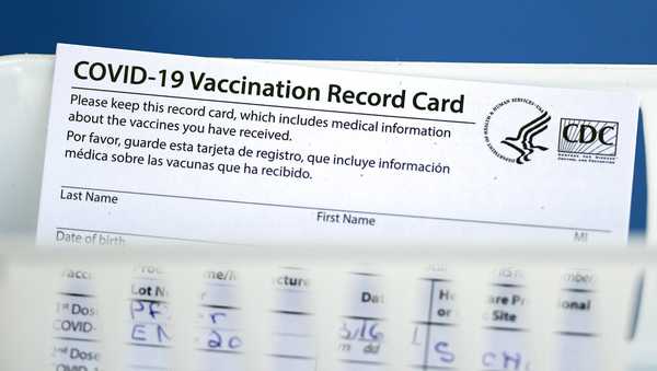 A vaccination record card is shown during a COVID-19 vaccination drive for Spring Branch Independent School District education workers Tuesday, March 16, 2021, in Houston. School employees who registered were given the Pfizer vaccine.(AP Photo/David J. Phillip)
