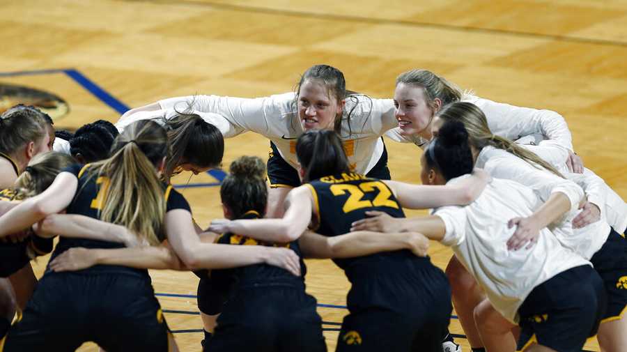 Iowa players cheer before the start of the first half of a college basketball game in the second round of the women&apos;s NCAA tournament at the Greehey Arena in San Antonio, Texas, Tuesday, March 23, 2021. (AP Photo/Ronald Cortes)