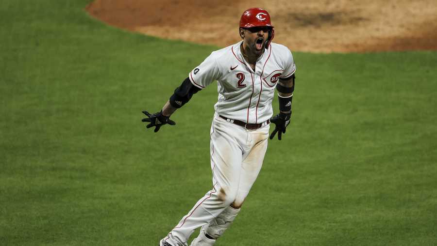 Cincinnati Reds' Nick Castellanos reacts to hitting a solo home run during the seventh inning of a baseball game against the Pittsburgh Pirates in Cincinnati, Monday, April 5, 2021. (AP Photo/Aaron Doster)