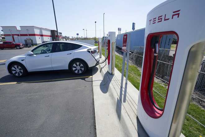 A&#x20;Tesla&#x20;charges&#x20;at&#x20;a&#x20;station&#x20;in&#x20;Topeka,&#x20;Kan.,&#x20;Monday,&#x20;April&#x20;5,&#x20;2021.&#x20;The&#x20;president&#x20;and&#x20;the&#x20;auto&#x20;industry&#x20;maintain&#x20;the&#x20;nation&#x20;is&#x20;on&#x20;the&#x20;cusp&#x20;of&#x20;a&#x20;gigantic&#x20;shift&#x20;to&#x20;electric&#x20;vehicles&#x20;and&#x20;away&#x20;from&#x20;liquid-fueled&#x20;cars,&#x20;but&#x20;biofuels&#x20;producers&#x20;and&#x20;some&#x20;of&#x20;their&#x20;supporters&#x20;in&#x20;Congress&#x20;aren&#x2019;t&#x20;buying&#x20;it.&#x20;They&#x20;argue&#x20;the&#x20;U.S.&#x20;should&#x20;increase&#x20;sales&#x20;of&#x20;ethanol&#x20;and&#x20;biodiesel,&#x20;not&#x20;abandon&#x20;them.&#x20;&#x28;AP&#x20;Photo&#x2F;Orlin&#x20;Wagner&#x29;