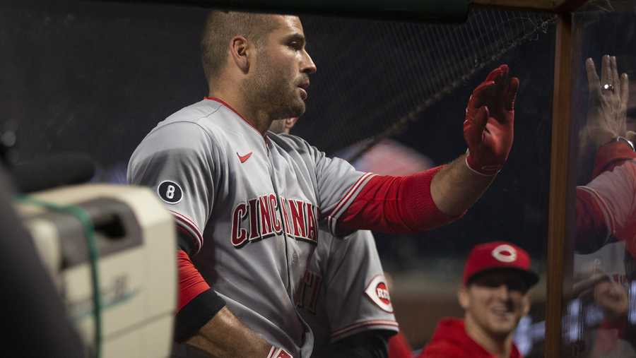 Cincinnati Reds first baseman Joey Votto (19) is greeted by his teammates after hitting a solo home run against the San Francisco Giants during the sixth inning of a baseball game, Monday, April 12, 2021, in San Francisco, Calif. (AP Photo/D. Ross Cameron)