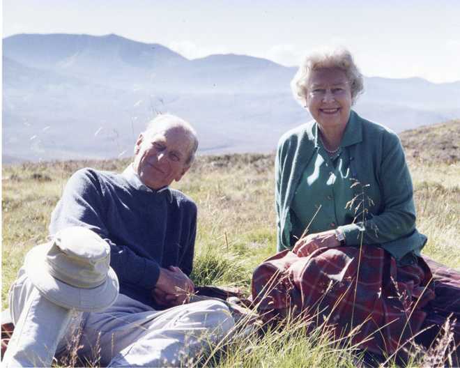 In this 2003 photo released by Buckingham Palace Friday April 16, 2021, a personal photograph of Queen Elizabeth II and Prince Philip Duke of Edinburgh at the top of the Coyles of Muick, Scotland, in this photo taken by Sophie The Countess of Wessex in 2003. (The Countess of Wessex/Buckingham Palace via AP)