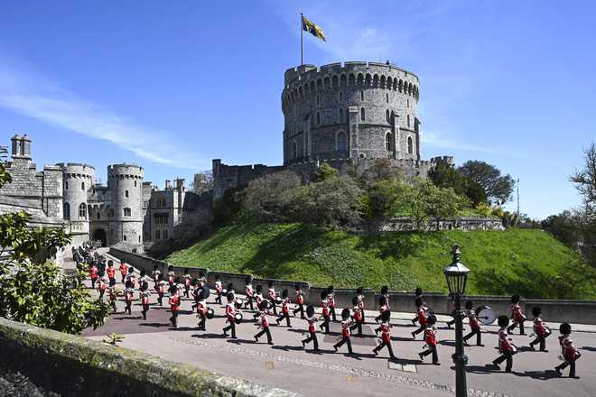 The Grenadier Guards make their way past the Round Tower during the funeral of Britain&amp;apos;s Prince Philip inside Windsor Castle in Windsor, England Saturday April 17, 2021. (Leon Neal/Pool via AP)